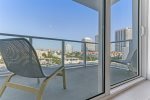 Balcony w/ patio chairs & views of city 